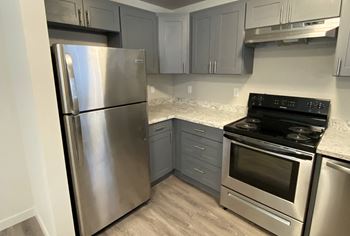 a kitchen with stainless steel appliances and marble counter tops at The Lakes Apartments, Moses Lake, WA 98837 